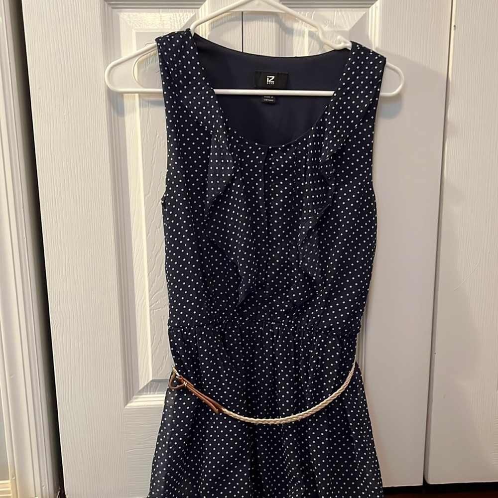 mid length navy blue dress with tan belt and white polka dots